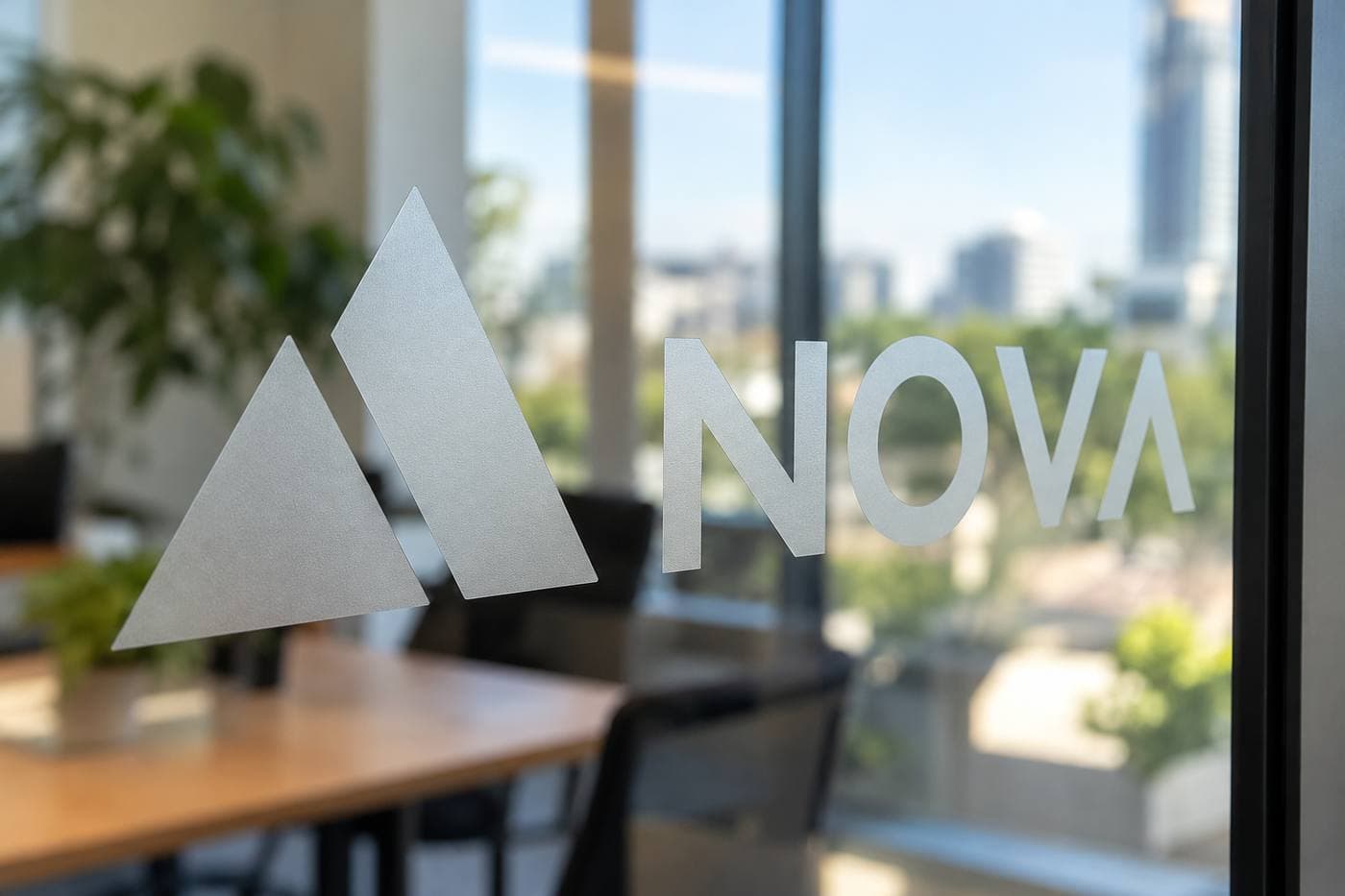 A frosted logo and the word NOVA on glass. The street is still visible through the film. Example.