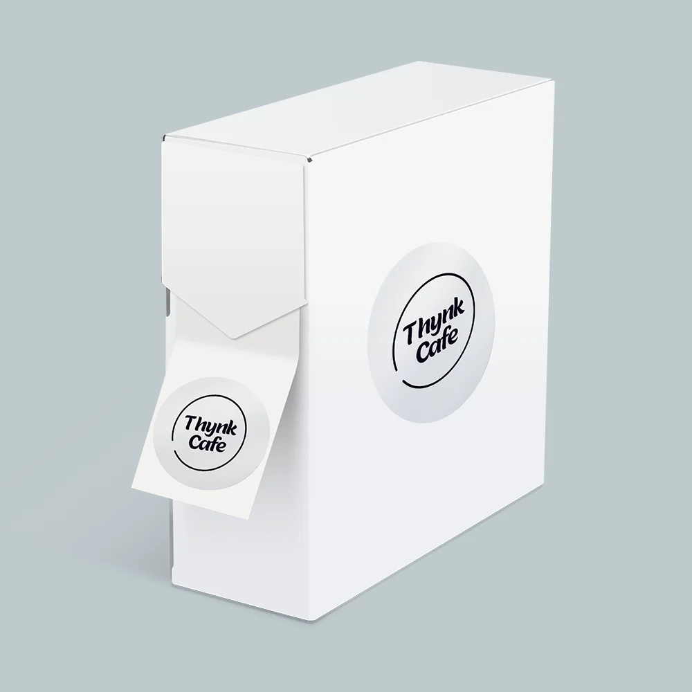 PVC transparent labels on a roll Ireland — branded café stickers in a dispenser box