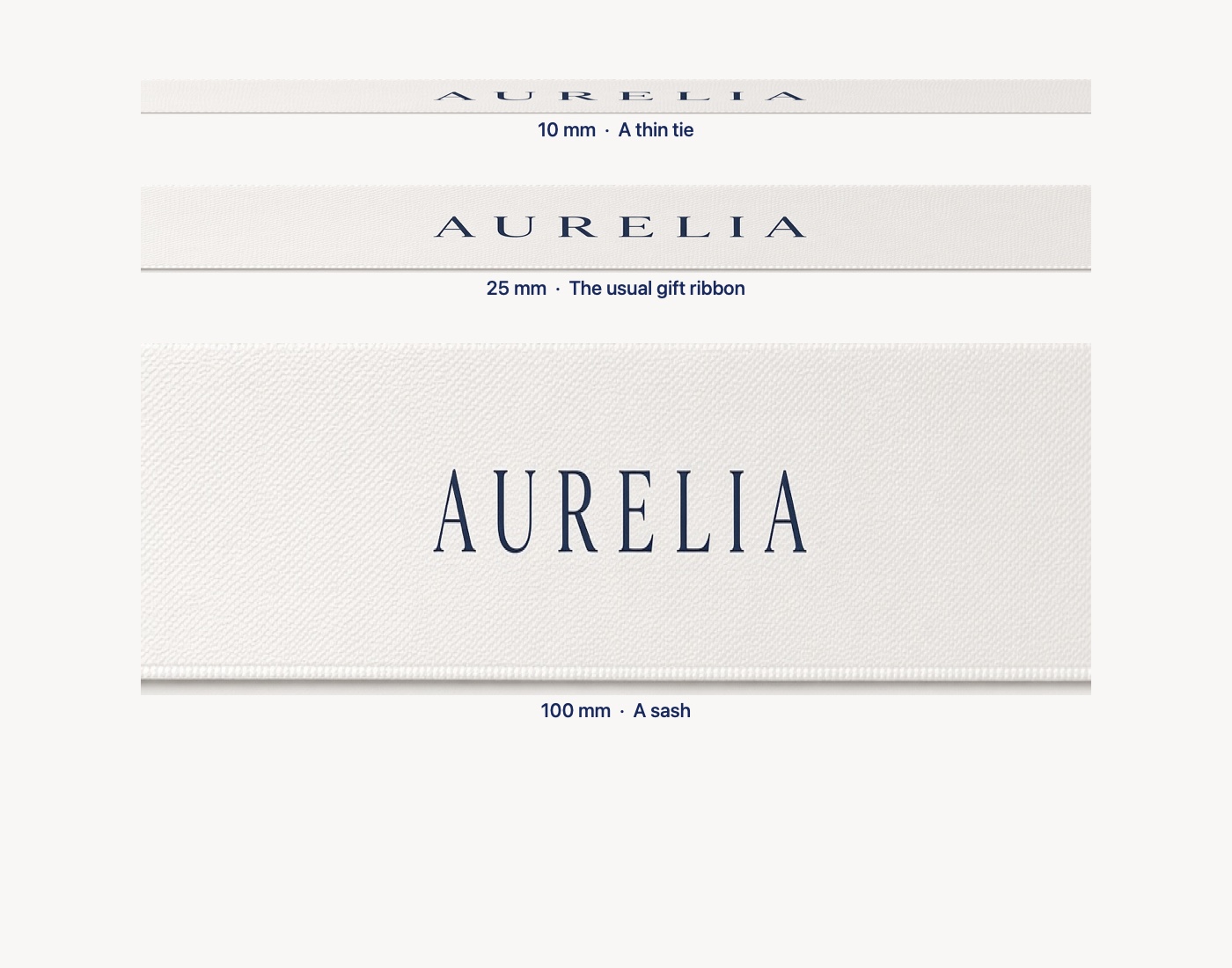 White satin ribbon at three widths, all the same length: 10 mm, a thin tie; 25 mm, the usual gift ribbon; 100 mm, a sash.